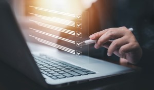 Businessman using a laptop and Taking an assessment, questionnai Businessman using a laptop and Taking an assessment, questionnaire, evaluation, online survey online exam Choosing the right answer in exam by filling out the online survey form,Answer test questions