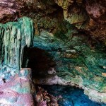 Stalactites and stalagmites in Kuza cave at Zanzibar, Tanzania. Natural pool with crystal clear water