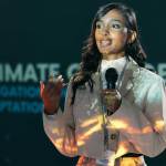 Woman-on-stage-speaking-in-microphone