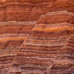 Fault lines and colorful layers in sandstone also useful as a background or texture.